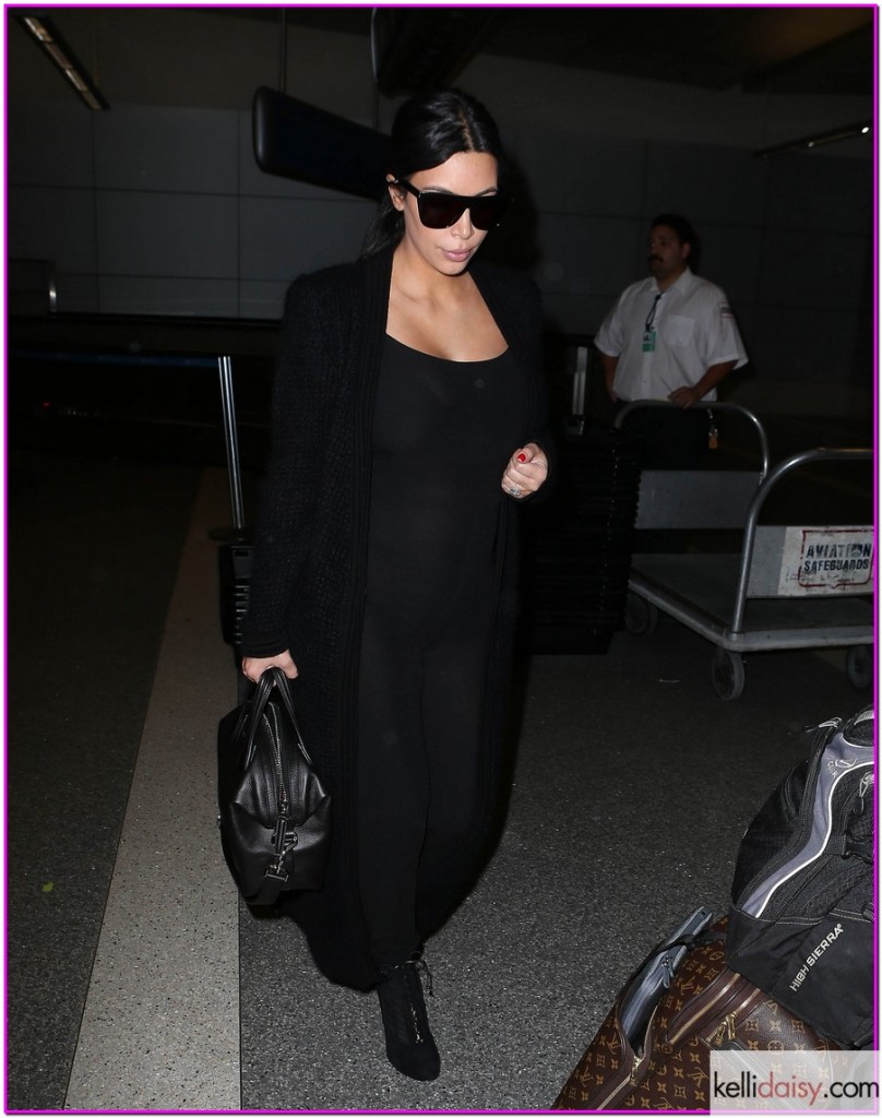 Pregnant Kim Kardashian Touches Down At LAX 51805835 Pregnant reality star kim Kardashian arriving on a flight at LAX airport in Los Angeles, California on July 22, 2015. Kim, who is currently pregnant with her second child, hid her growing baby bump under a tight black jumpsuit. FameFlynet, Inc - Beverly Hills, CA, USA - +1 (818) 307-4813