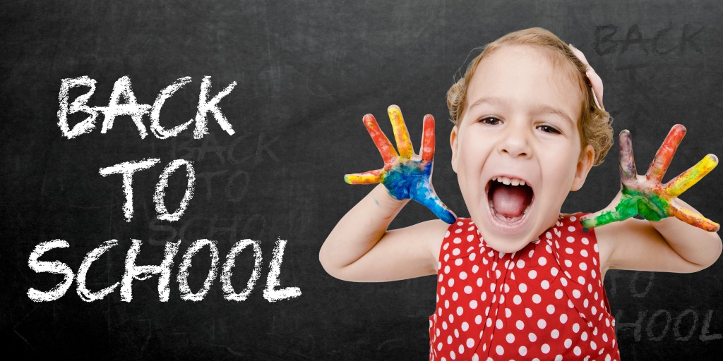 Positive child with colorful hands by sign back to school