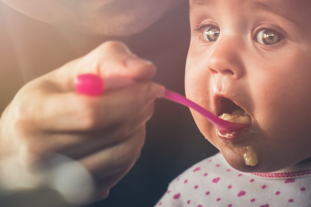 Feeding a five month old baby with a spoon