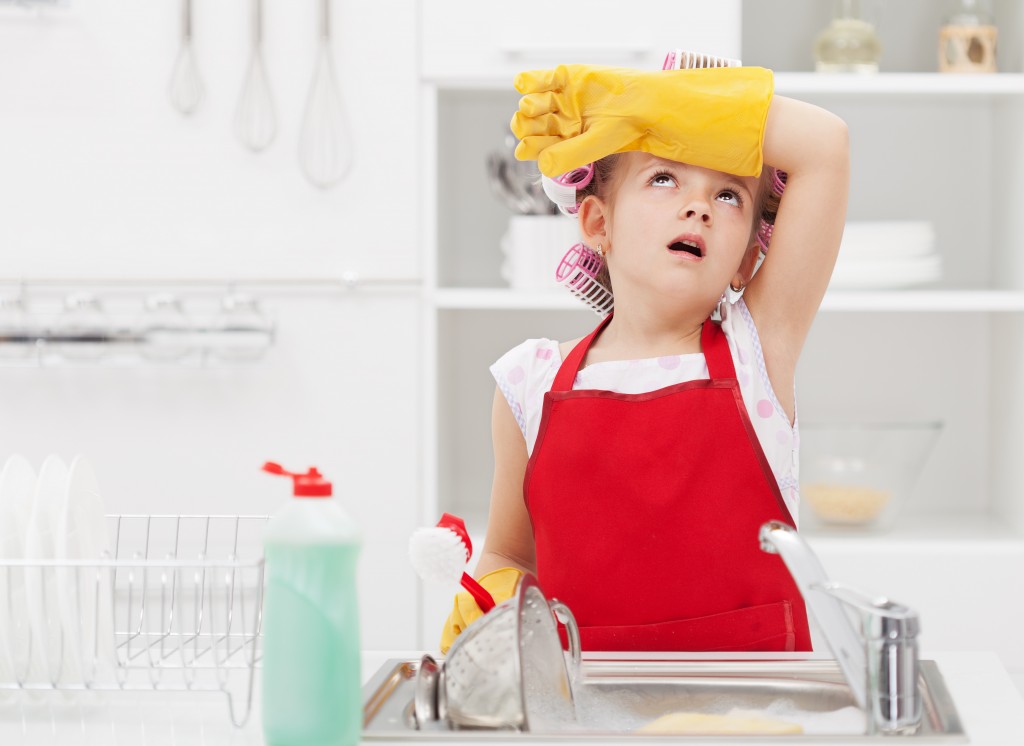 Little housekeeping fairy girl tired of home chores - doing the dishes