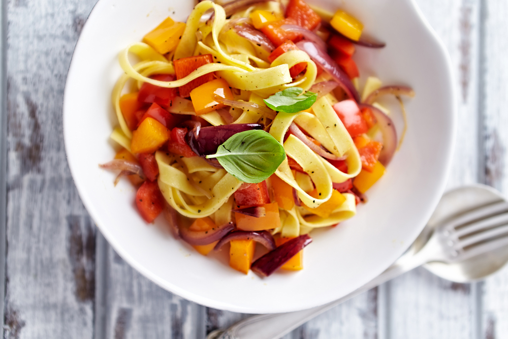 Bowl of Taglietelle pasta with peppers, onions and fresh basil, recipe taglietelle with peppers