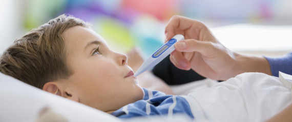 Mother taking son's temperature