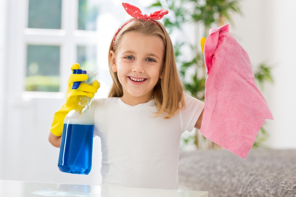 Happy smiling girl successful doing housework obligations