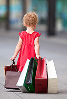 Little_girl_dragging_shopping_bags