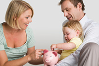 Parentschildputtingmoneyinpiggybank