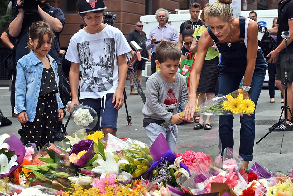 children-lay-flowers-at-martin-place-data