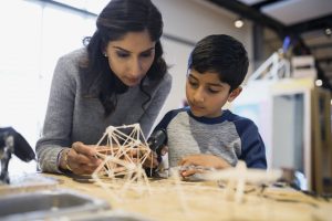 Mother and son assembling toothpick model science center