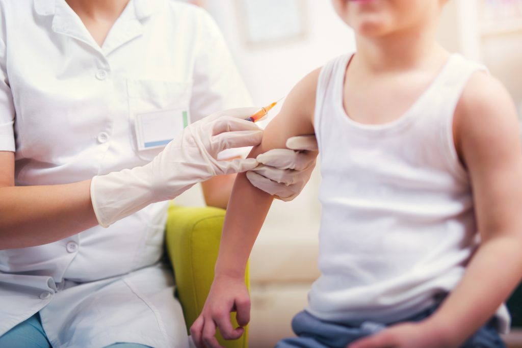 Pediatrician makes vaccination to small boy