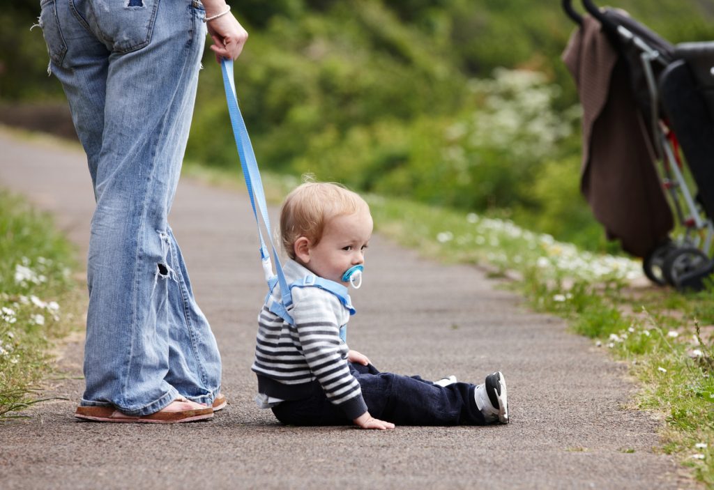 Cute 18 month old boy on footpath