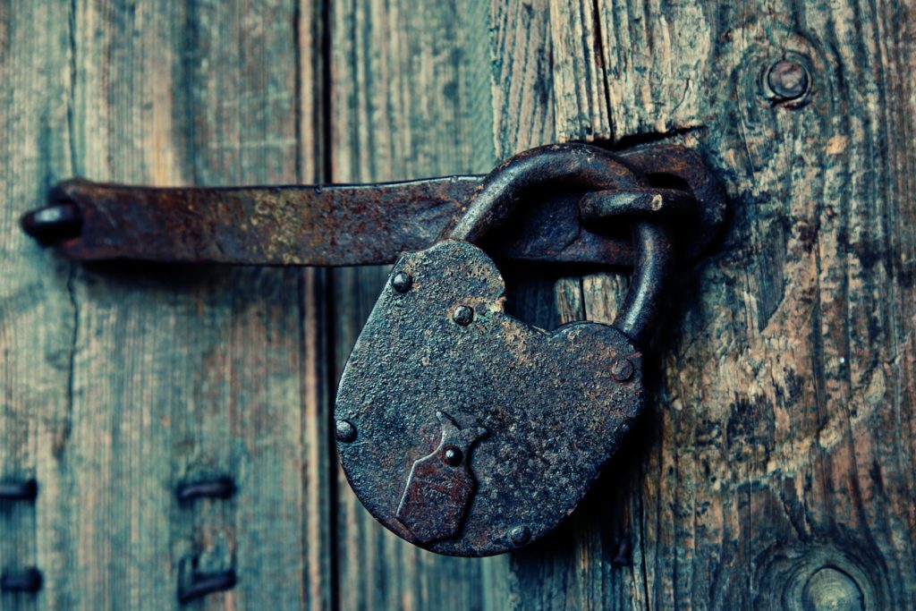 An old wooden door with an old lock. storehouse