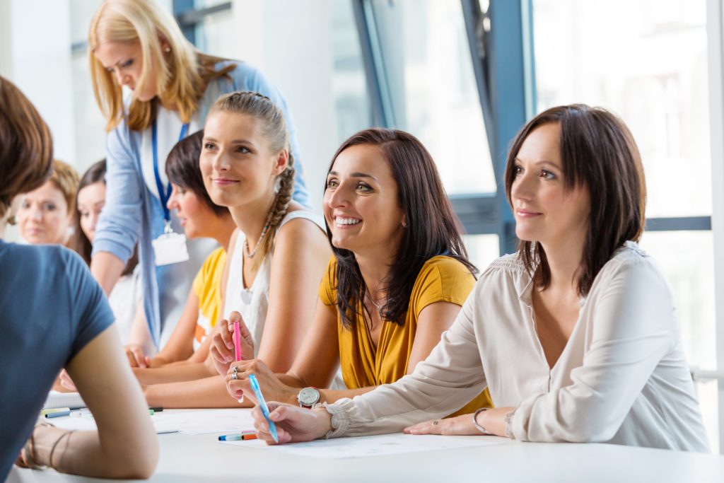 Group of women attending a training, working together and discussing.