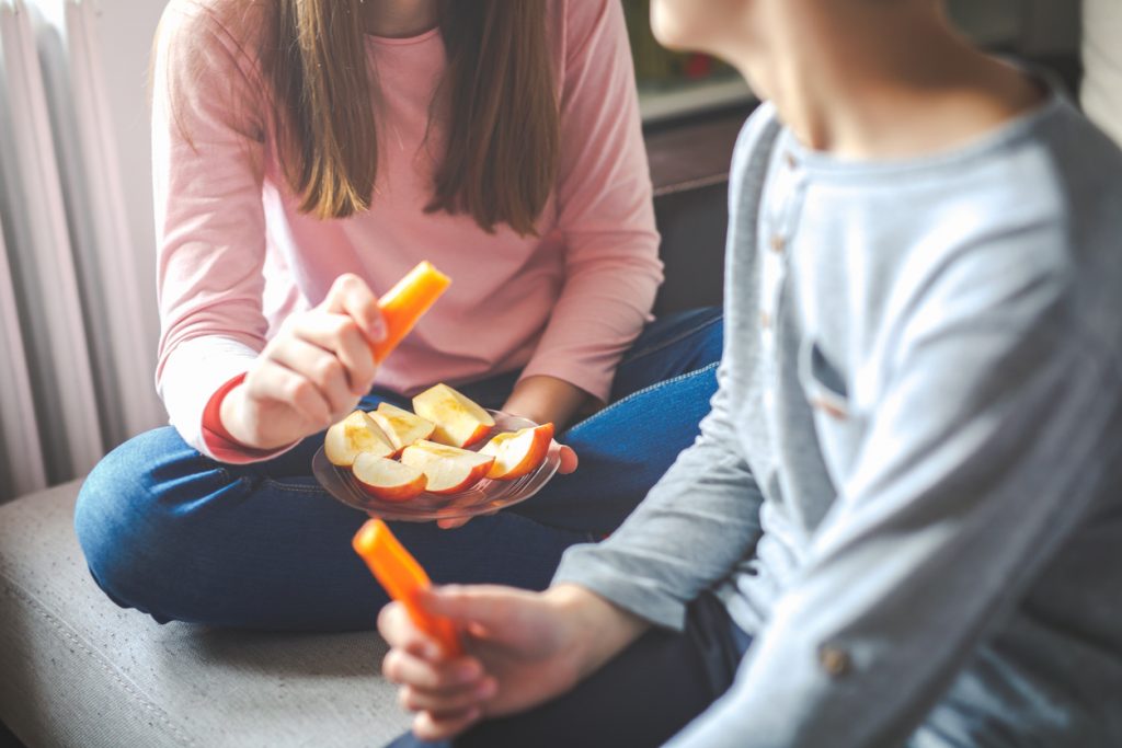 Fruits and vegetables in hands children