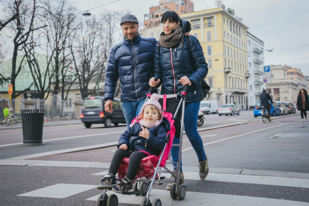 Happy family crossing the street.
