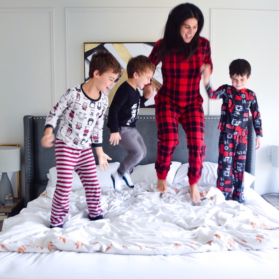 family pic jumping on bed
