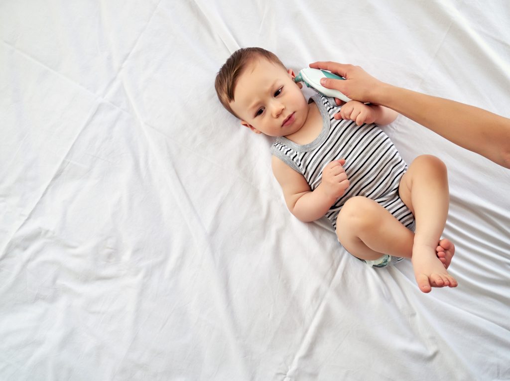 Mother measuring baby's temperature