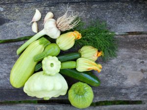 Different varieties of squash and zucchini on wood table