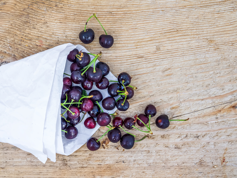 Superfoods we love cherries, whole ripe cherries on wooden board