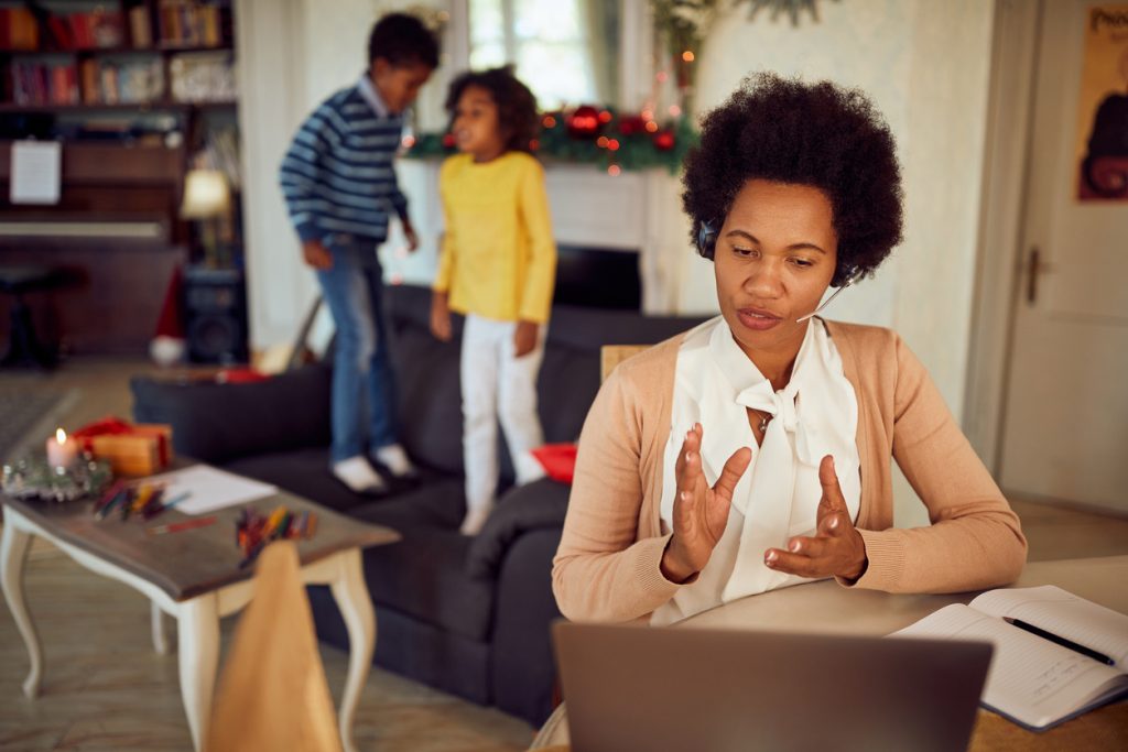 African American working mother having video call over laptop at home during Christmas holiday. Work from Home Parents Gift Ideas - SavvyMom