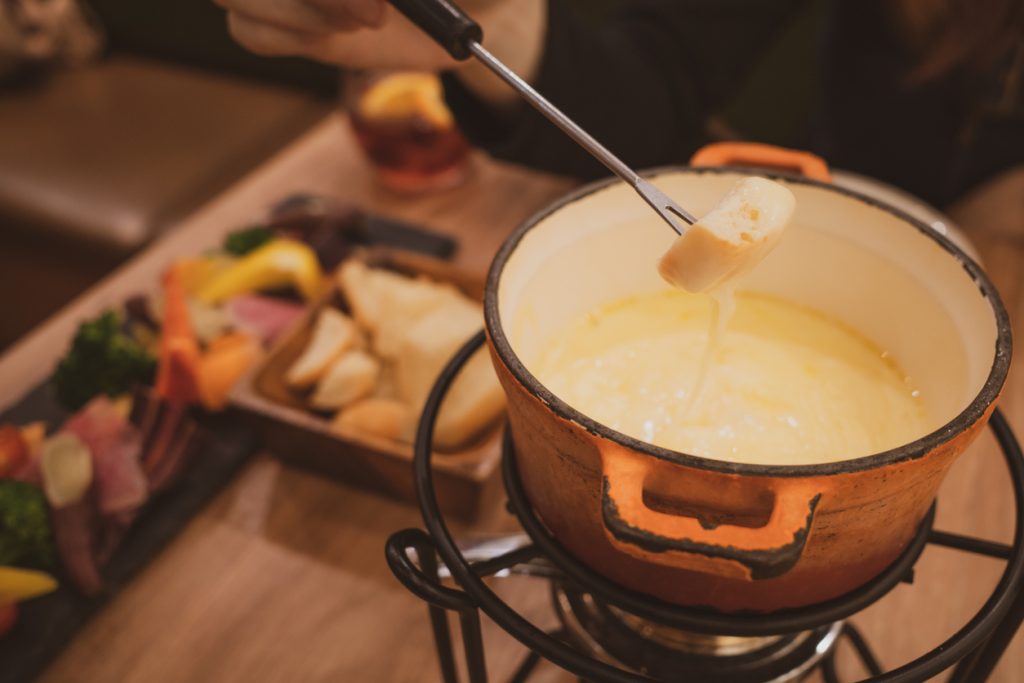 Scenery of eating cheese fondue with family Family-Friendly Fondue - SavvyMom
