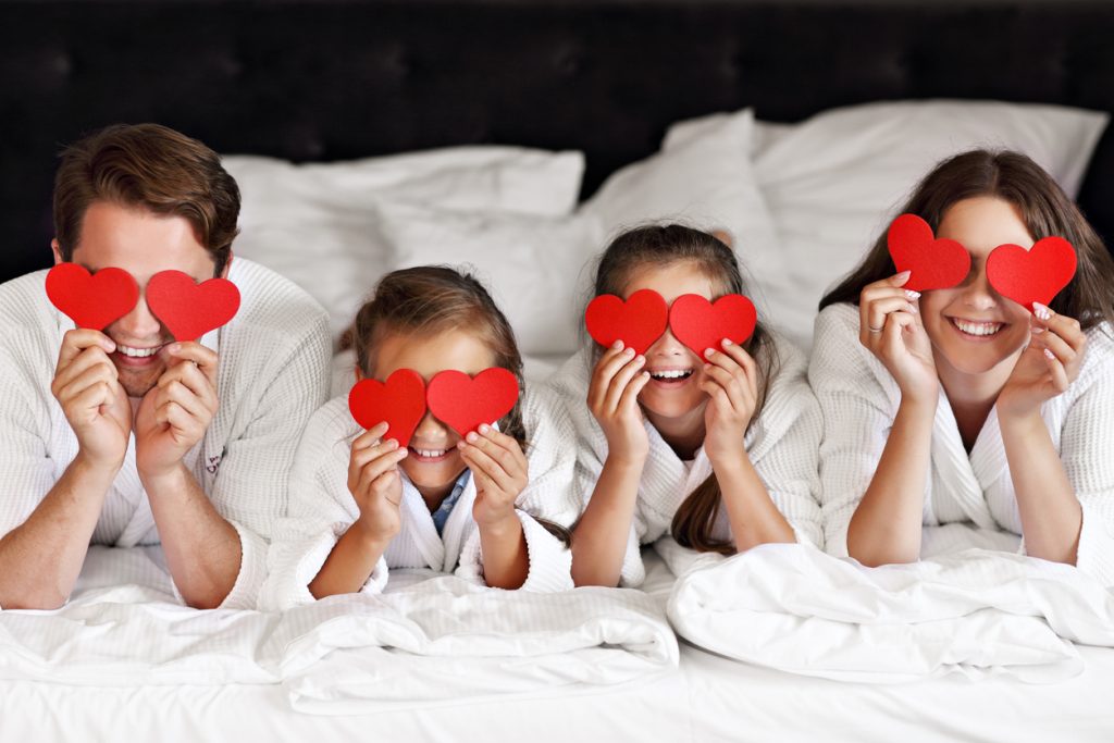 Happy family relaxing in hotel room Valentines Day in Toronto - SavvyMom