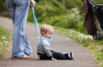 Cute 18 month old boy on footpath
