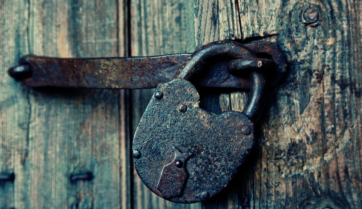 An old wooden door with an old lock. storehouse