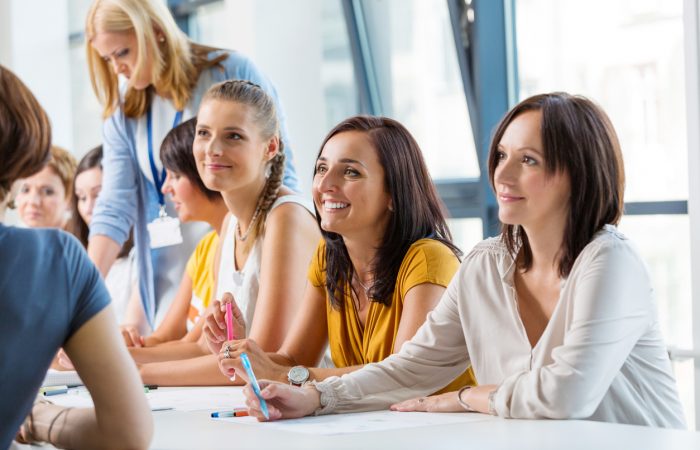 Group of women attending a training, working together and discussing.