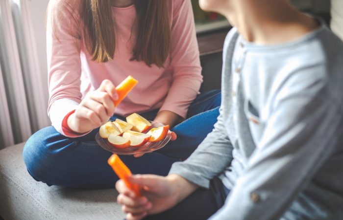 Fruits and vegetables in hands children