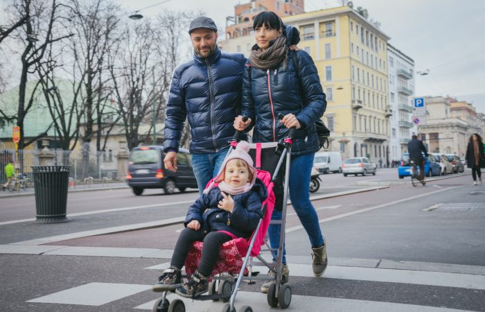 Happy family crossing the street.