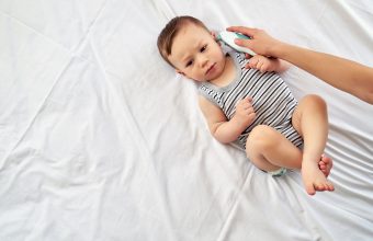 Mother measuring baby's temperature