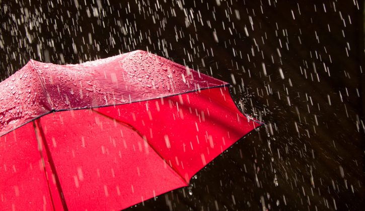 Red Umbrella and Rain Against Black Background