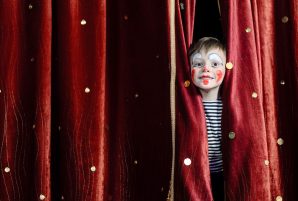 Kid Peeking Through Stage Curtain