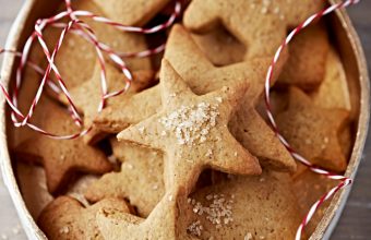 Tips for cookie swap, gingerbread star-shaped cookies in a holiday tin