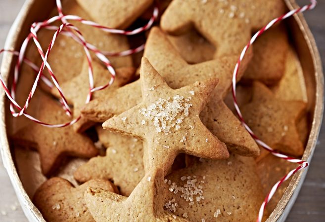 Tips for cookie swap, gingerbread star-shaped cookies in a holiday tin