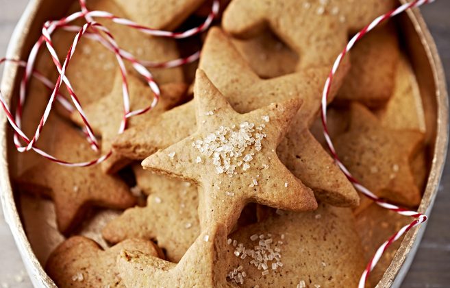Tips for cookie swap, gingerbread star-shaped cookies in a holiday tin