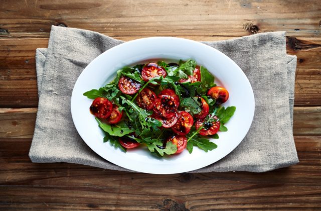 Arugula salad with cherry tomatoes and balsamic vinegar
