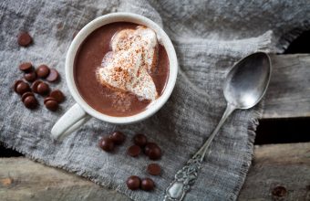 Mug of sliced hot chocolate with whipped cream