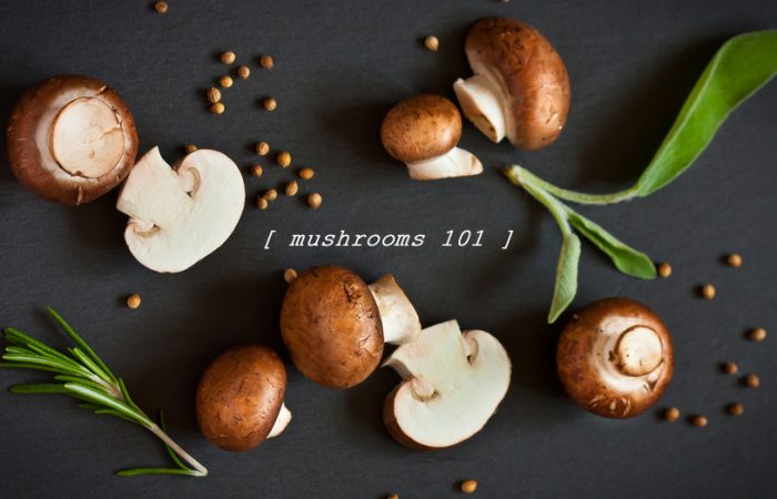 Mushrooms 101, cremini mushrooms on black surface with herbs