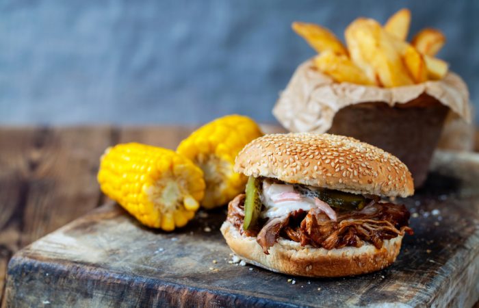 Pulled Pork sandwich with fries and corn on the cobb