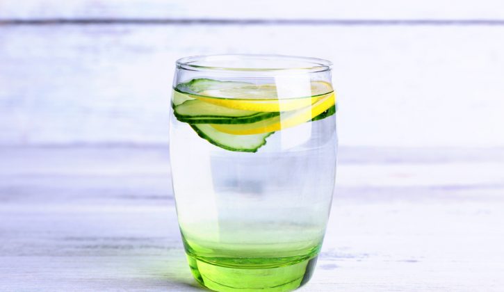 8 Reasons You should be drinking lemon water, glass of water with lemon and cucumber slices