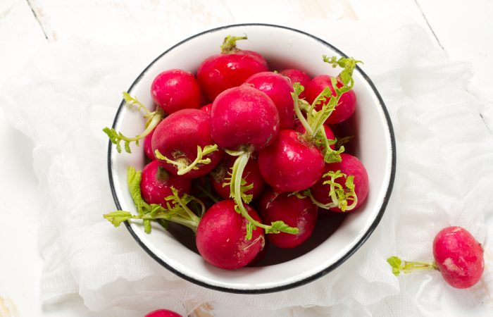 Whole Red radishes in white bowl