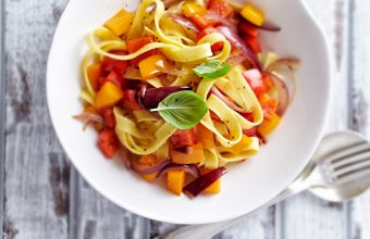 Bowl of Taglietelle pasta with peppers, onions and fresh basil, recipe taglietelle with peppers