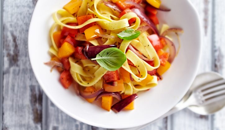Bowl of Taglietelle pasta with peppers, onions and fresh basil, recipe taglietelle with peppers