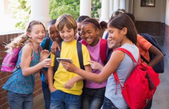 stockfresh_5830711_cute-pupils-using-mobile-phone_sizeXS