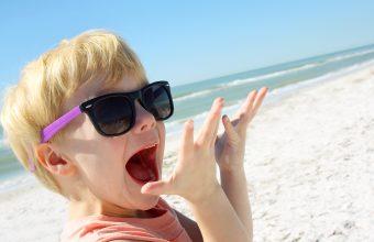 Excited Child on Beach by Ocean