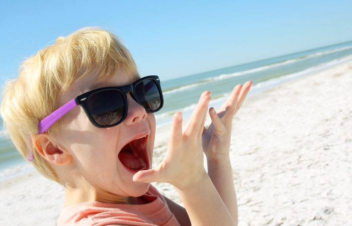 Excited Child on Beach by Ocean