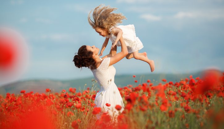 beautiful mother and little daughter in a field in summer