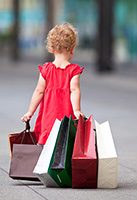 Little_girl_dragging_shopping_bags