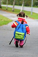 toddler_walking_with_backpack_on