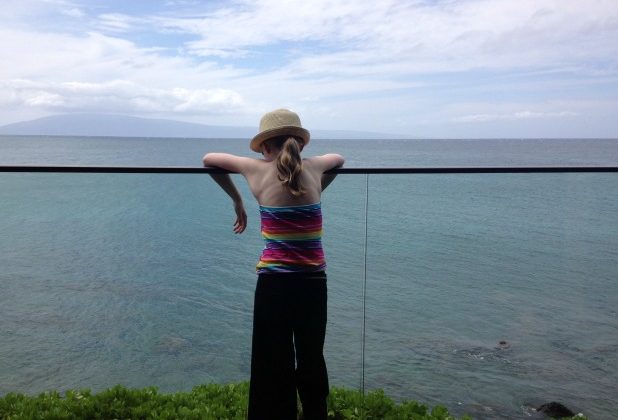 Girl-looking-at-ocean-from-balcony